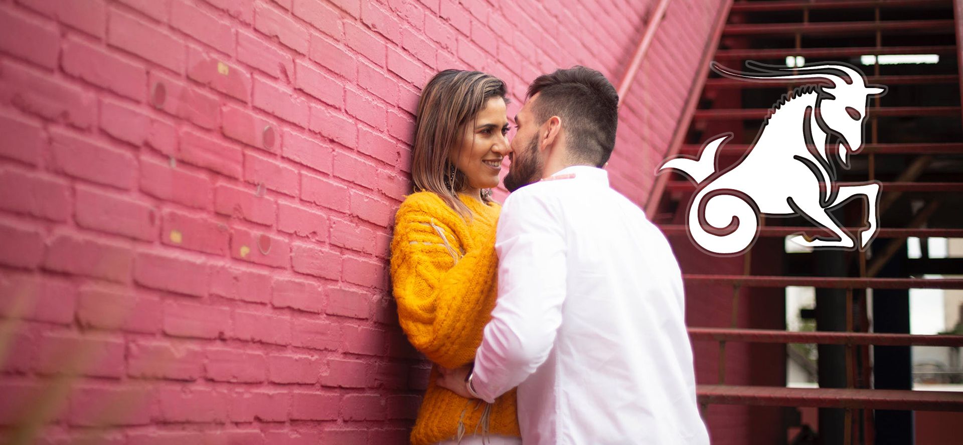 Capricorn man kisses woman.