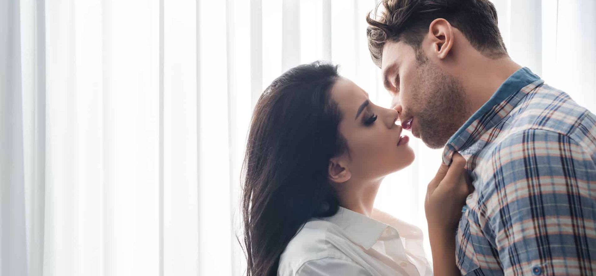 A Capricorn man kisses a woman.