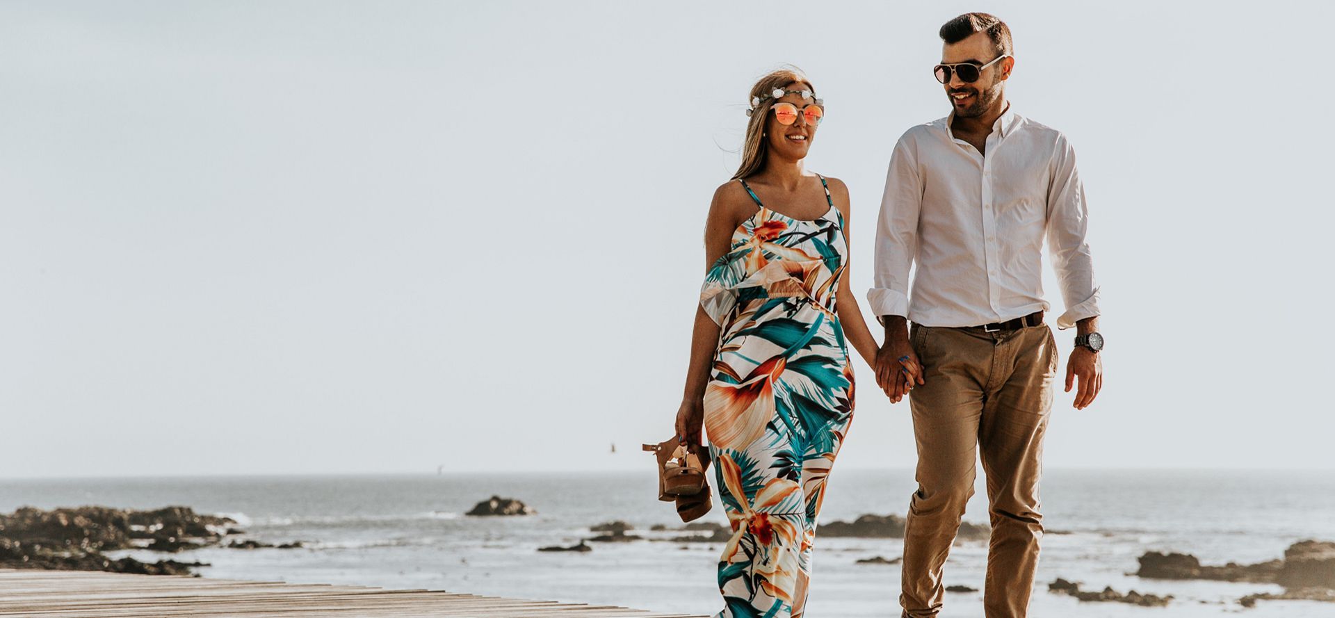 Taurus man walking with woman on the beach.