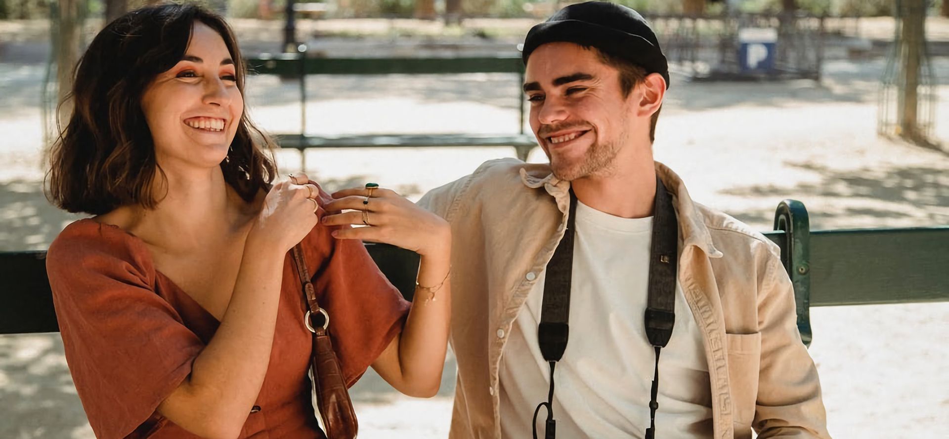 Sagittarius man talking with woman on bus stop.