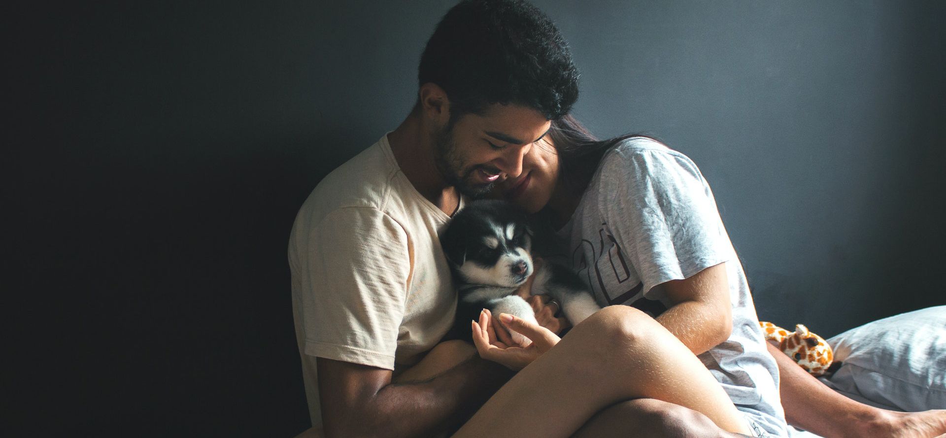 Sagittarius man with woman petting the dog.