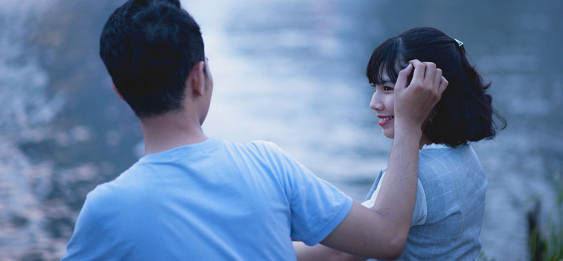 Scorpio man fixes a woman's hair.