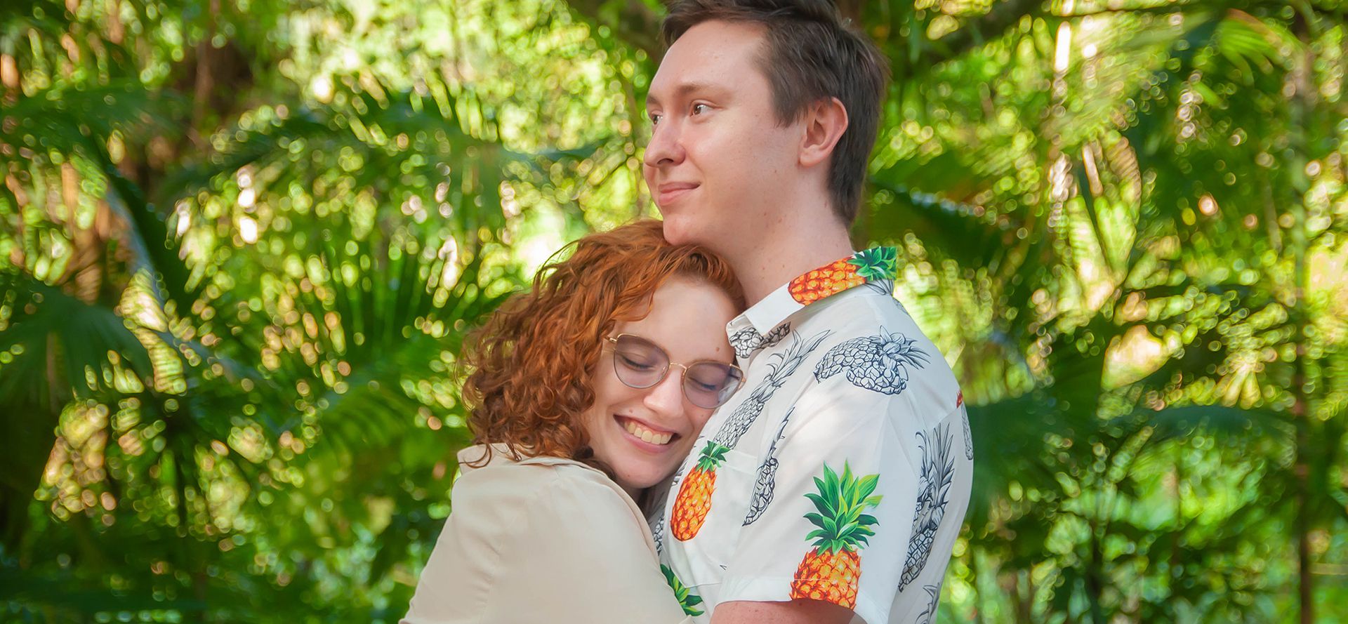 Woman hugging a capricorn man in the forest.