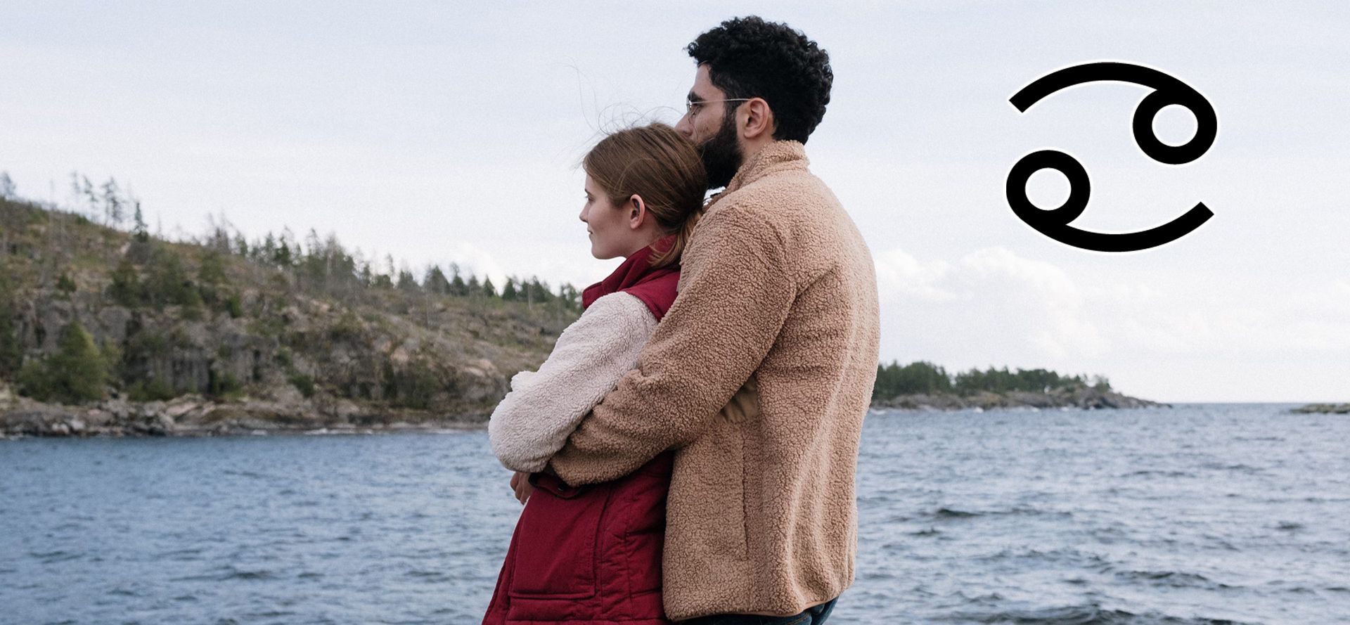 Cancer man hugging a woman near a lake.