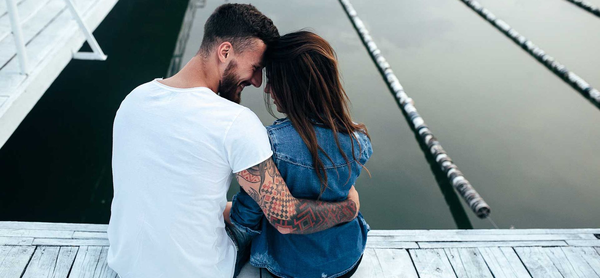 Virgo man and woman sitting on the dock.